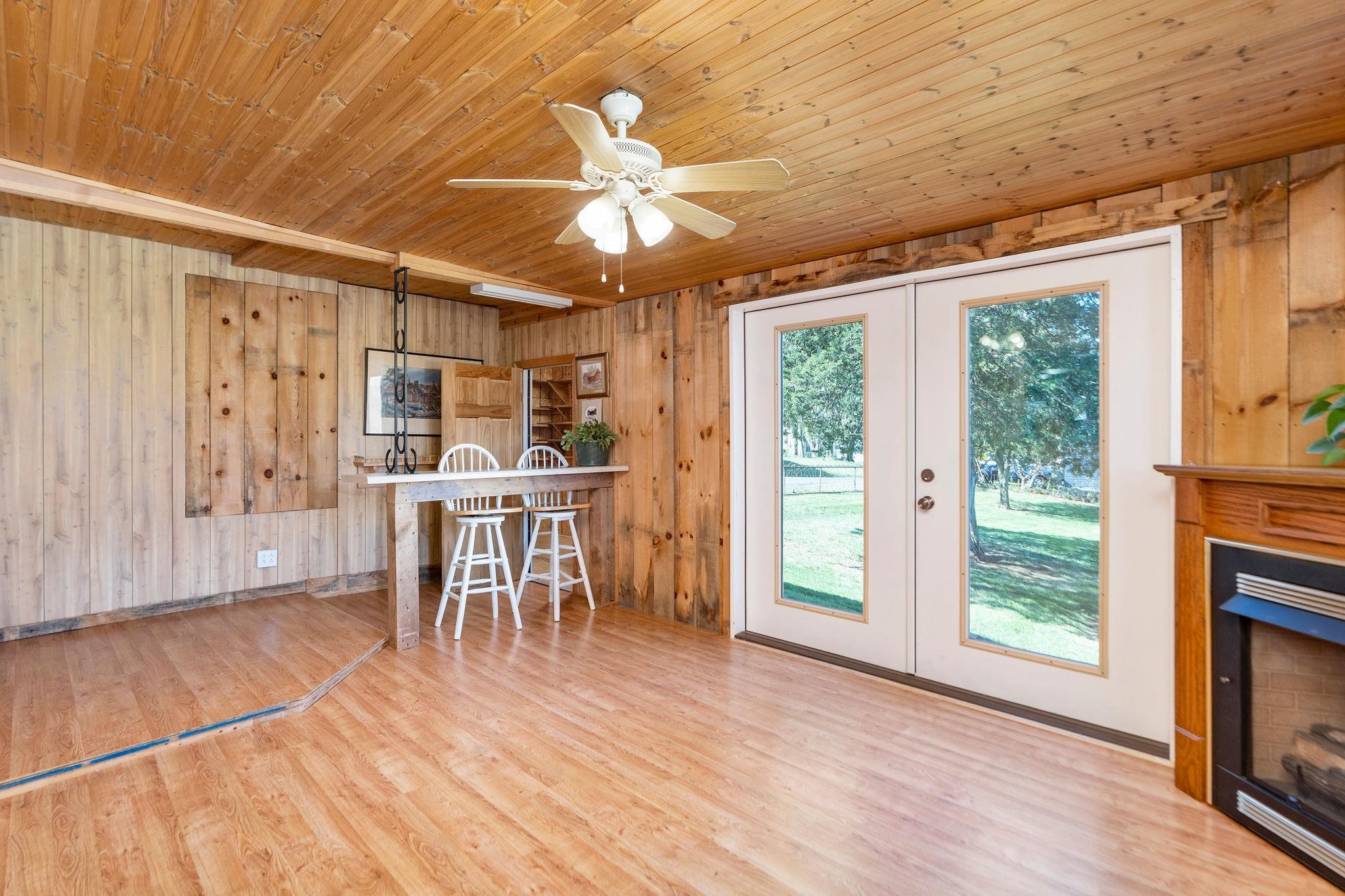 2061 Cecil Wampler Road Mount Crawford, VA 22841 - Photo 18 of 70 a dining room with wooden floor a flat screen tv and a fireplace