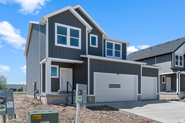 2829 North 710 West, Unit 15 Logan, UT 84321 - Photo 2 of 23 Modern two-story residence with dark gray siding, prominent white trim, and a dual-bay garage