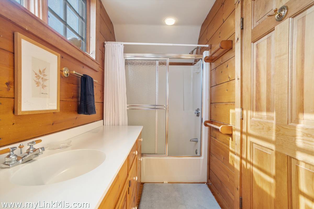 13 Eat Fire Spring Road Nantucket, MA 02554 - Photo 31 of 43 a bathroom with a tub a sink and a large mirror