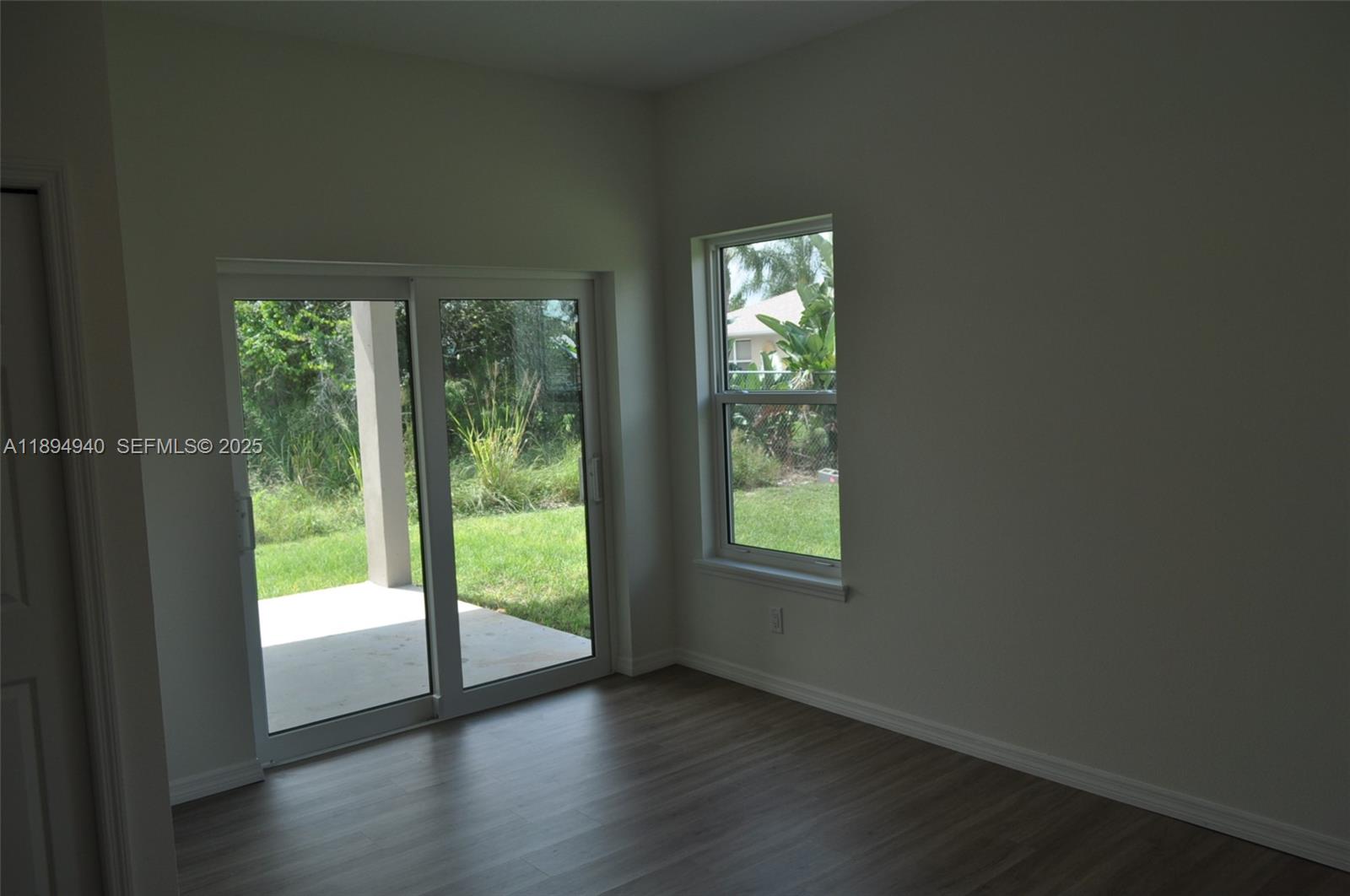 4125 Mandarin Road, Unit 4125 Sebring, FL 33875 - Photo 12 of 18 a view of an empty room with wooden floor and a window