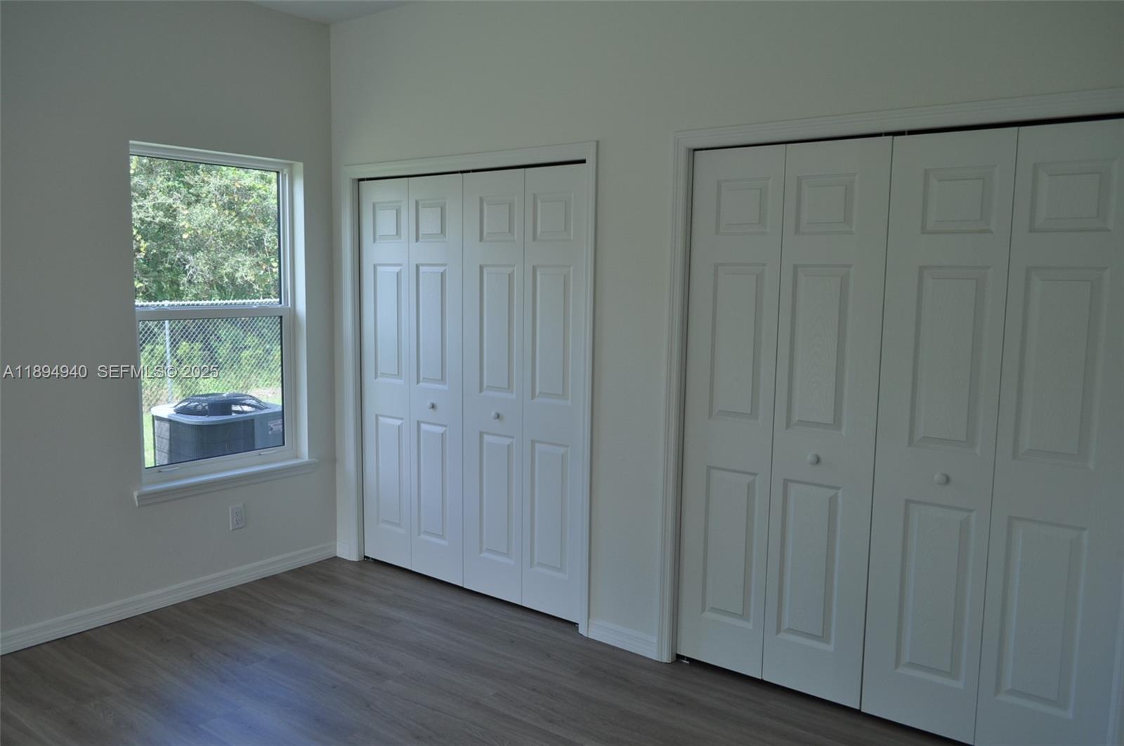 4125 Mandarin Road, Unit 4125 Sebring, FL 33875 - Photo 10 of 18 a view of an empty room with wooden floor and a window