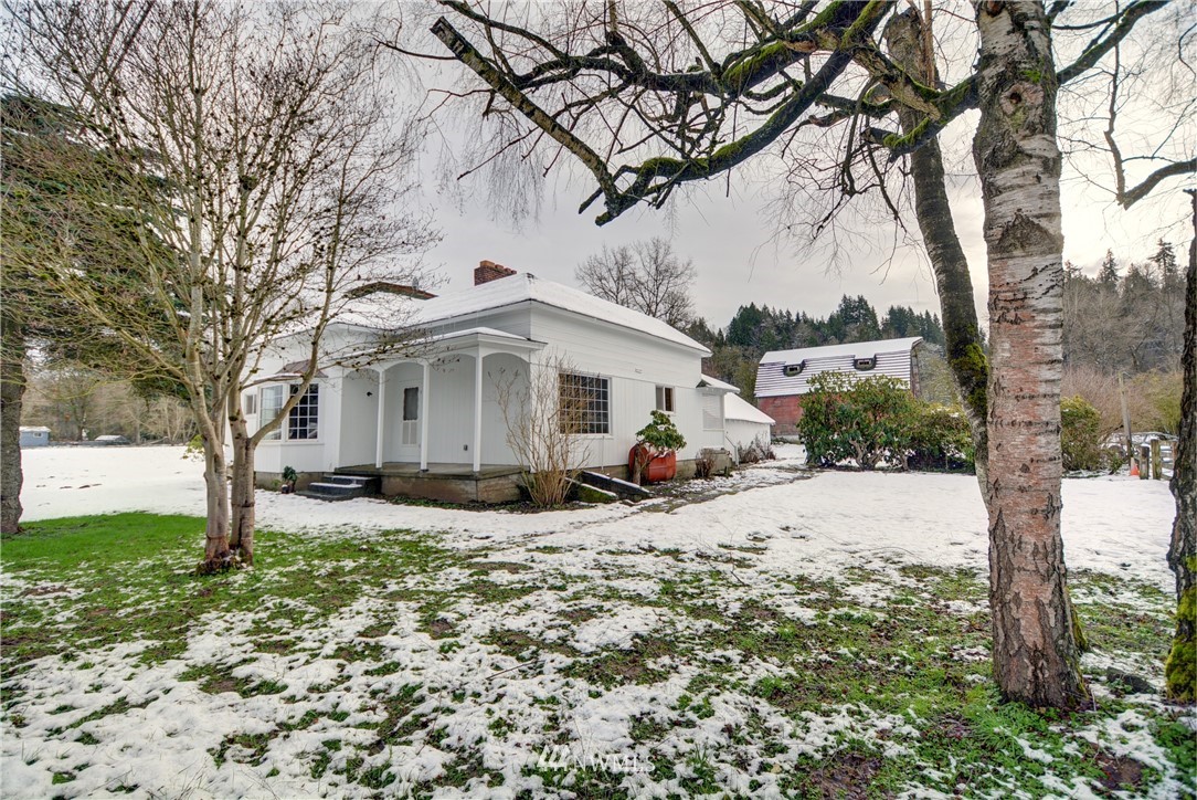 a view of a house with a yard covered in snow