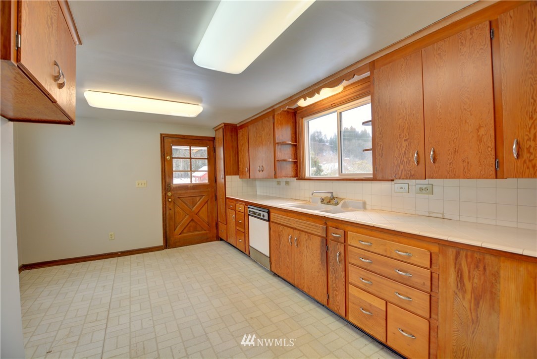 1603 South Machias Road Snohomish, WA 98290 - Photo 3 of 28 a large kitchen with stainless steel appliances granite countertop a sink and cabinets with wooden floor