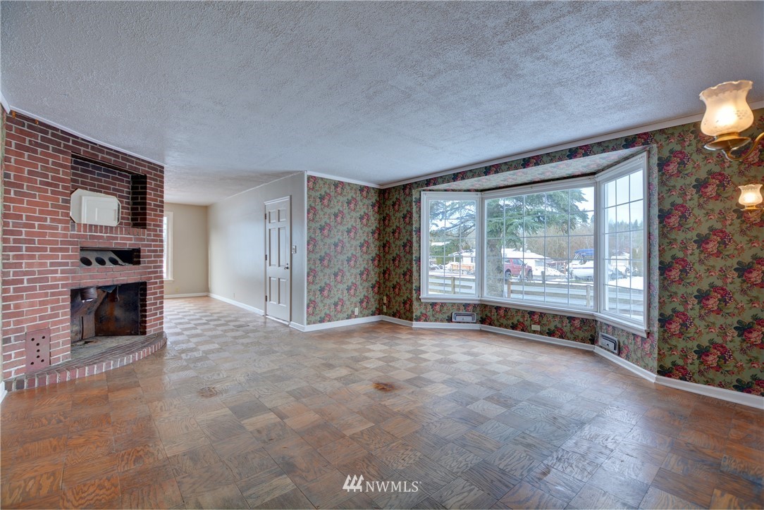 1603 South Machias Road Snohomish, WA 98290 - Photo 6 of 28 a view of a livingroom with an empty space and a fireplace