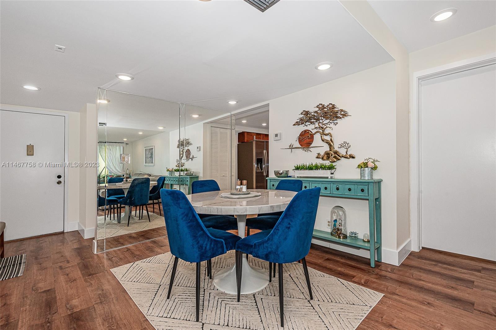 16401 Golf Club Road, Unit 311 Weston, FL 33326 - Photo 11 of 33 a view of a dining room with furniture and wooden floor