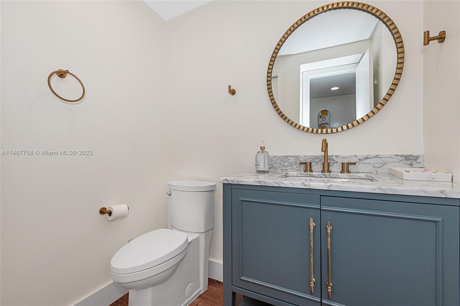 16401 Golf Club Road, Unit 311 Weston, FL 33326 - Photo 17 of 33 a bathroom with a granite countertop sink mirror and toilet