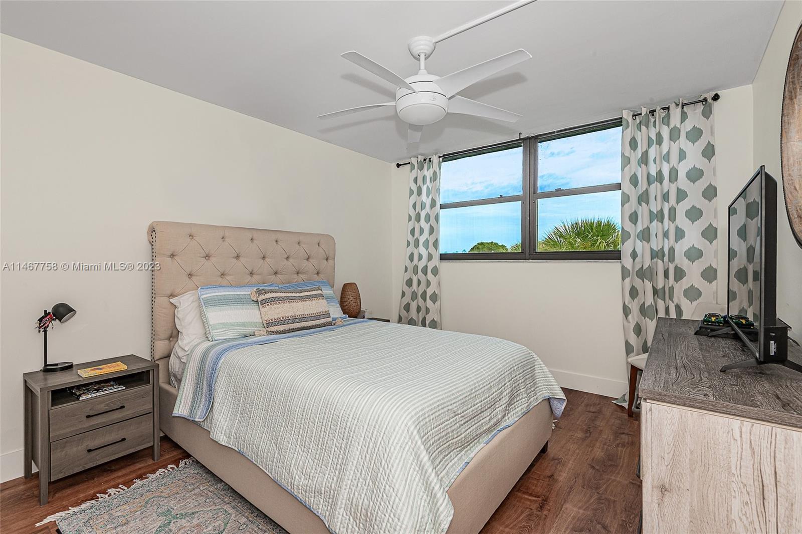 16401 Golf Club Road, Unit 311 Weston, FL 33326 - Photo 18 of 33 a bedroom with a bed and a flat screen tv