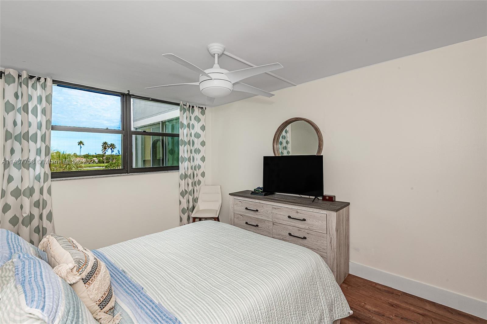16401 Golf Club Road, Unit 311 Weston, FL 33326 - Photo 19 of 33 a bedroom with a bed and a flat screen tv
