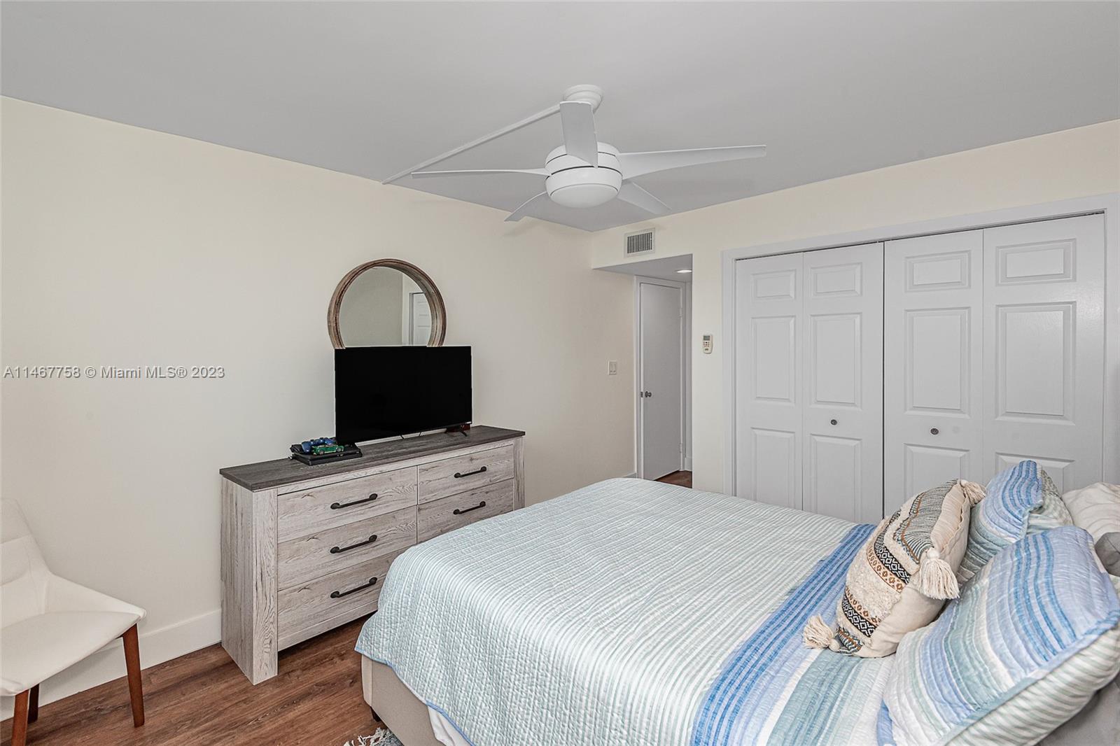 16401 Golf Club Road, Unit 311 Weston, FL 33326 - Photo 20 of 33 a bedroom with a bed and a flat screen tv