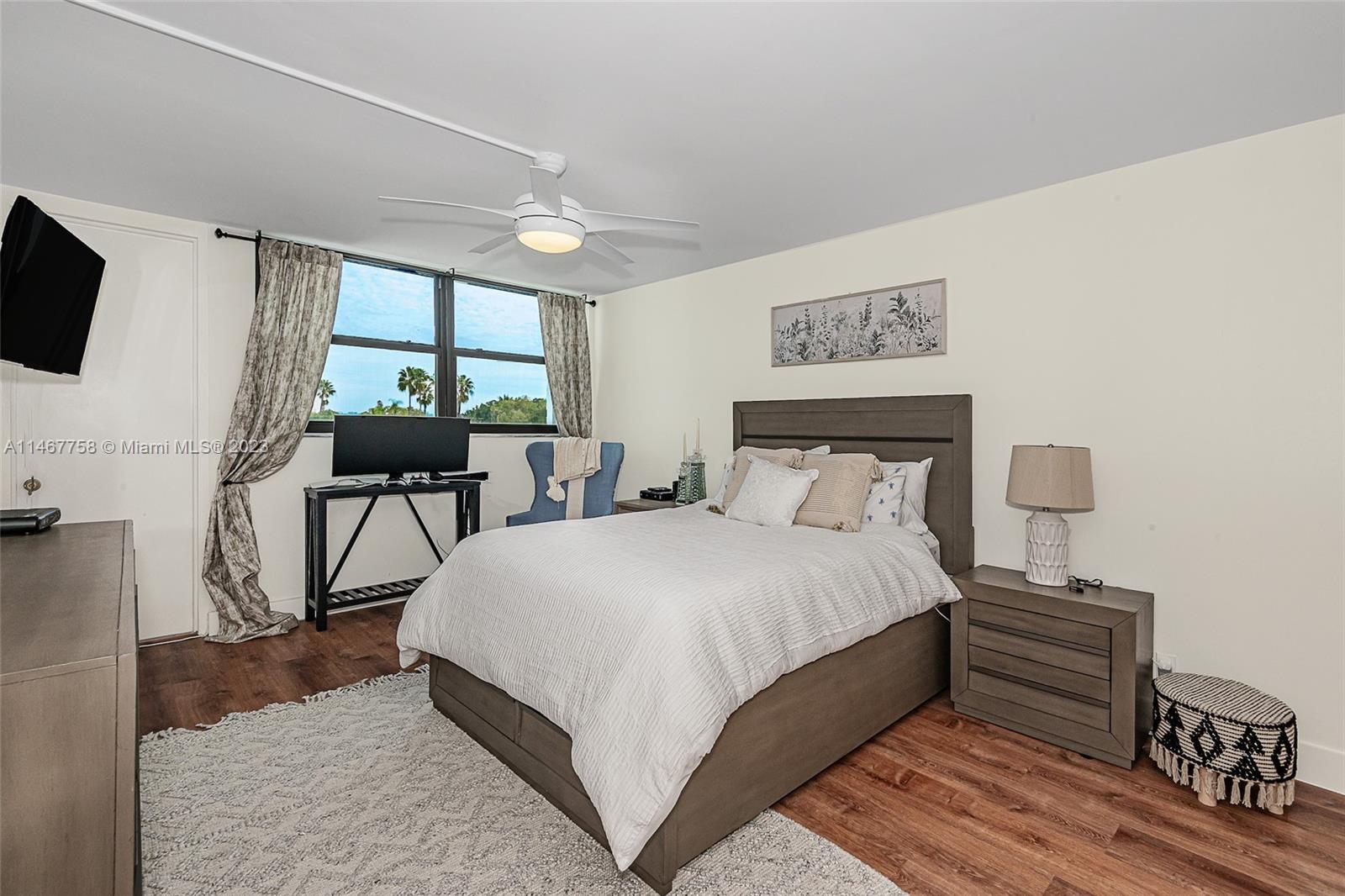 16401 Golf Club Road, Unit 311 Weston, FL 33326 - Photo 23 of 33 a large bedroom with bed tv and table