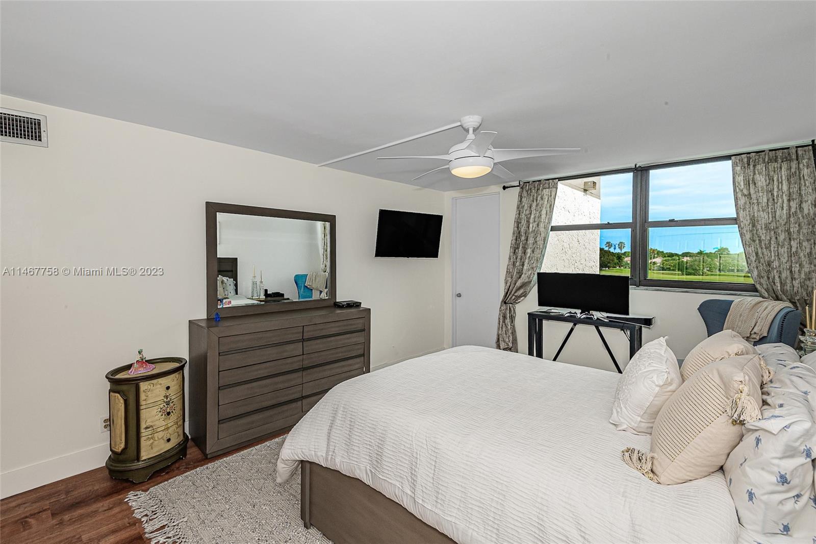 16401 Golf Club Road, Unit 311 Weston, FL 33326 - Photo 24 of 33 a bed room with a bed and a television