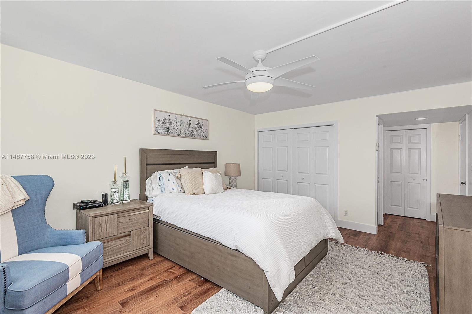 16401 Golf Club Road, Unit 311 Weston, FL 33326 - Photo 25 of 33 a bedroom with a large bed and a couch