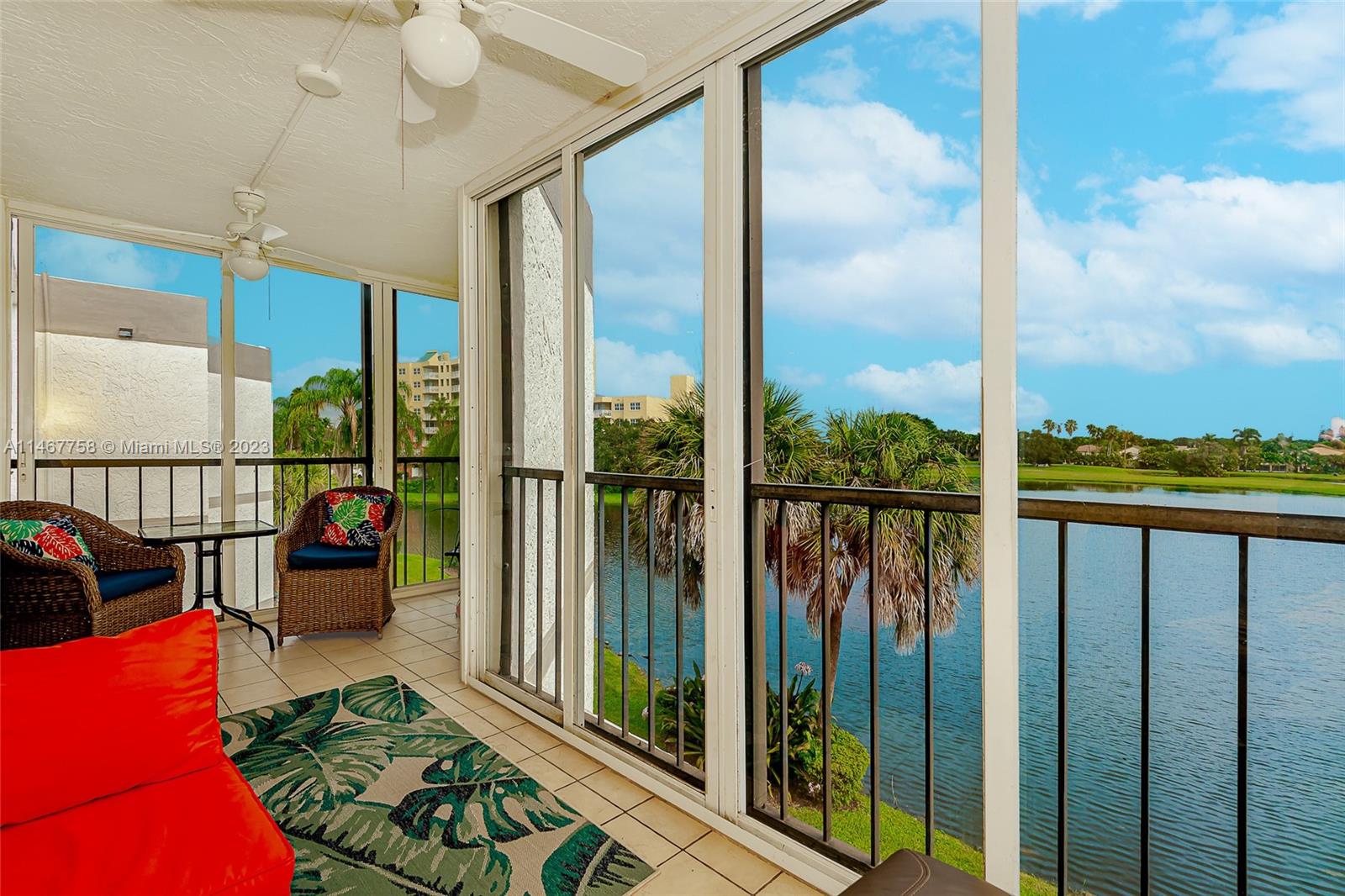16401 Golf Club Road, Unit 311 Weston, FL 33326 - Photo 30 of 33 a view of a balcony with floor to ceiling windows with wooden floor