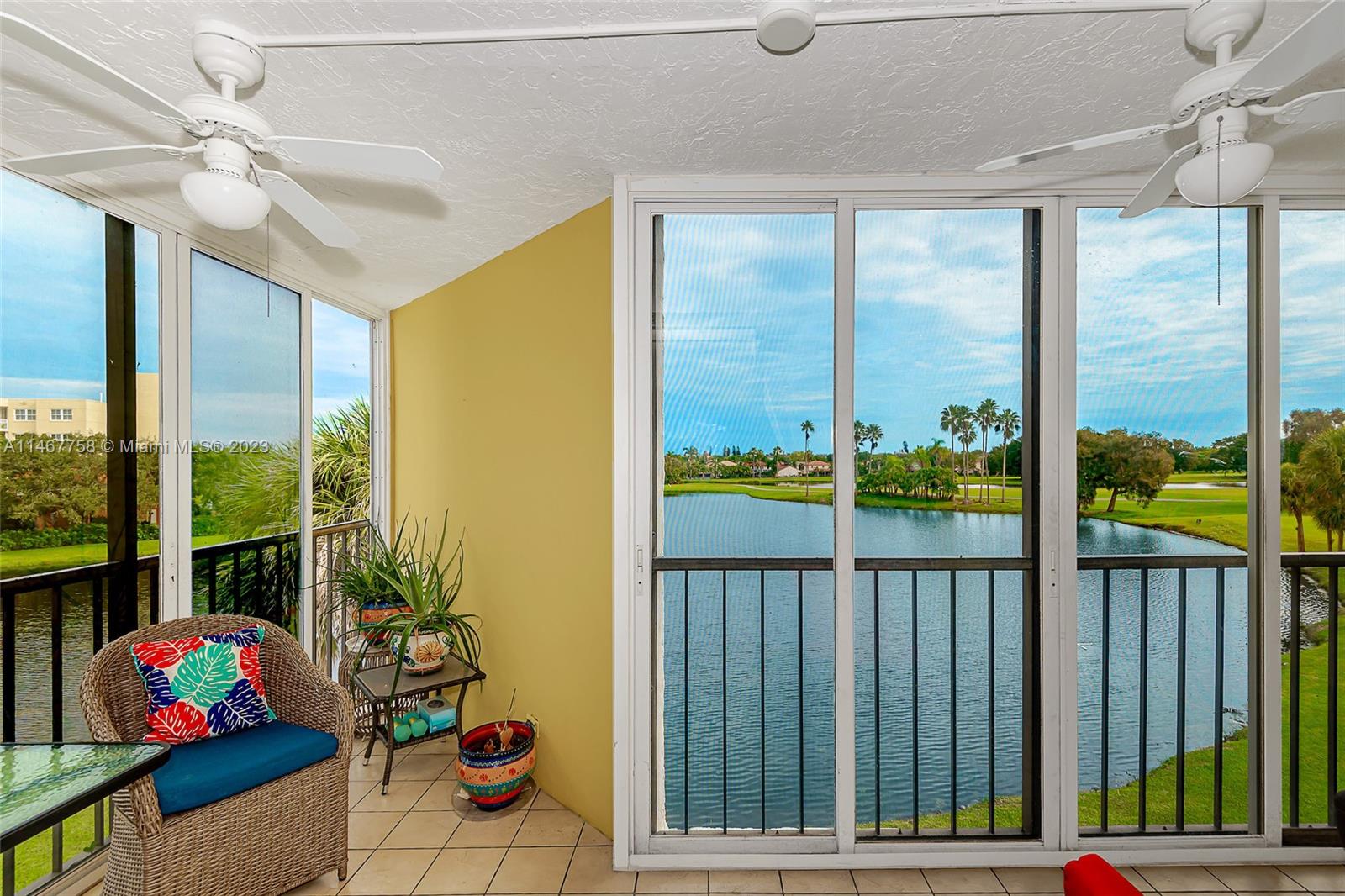16401 Golf Club Road, Unit 311 Weston, FL 33326 - Photo 31 of 33 a living room filled with furniture and a potted plant