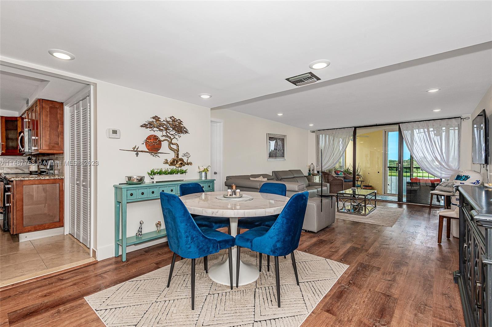 16401 Golf Club Road, Unit 311 Weston, FL 33326 - Photo 5 of 33 a view of a dining room with furniture window and wooden floor