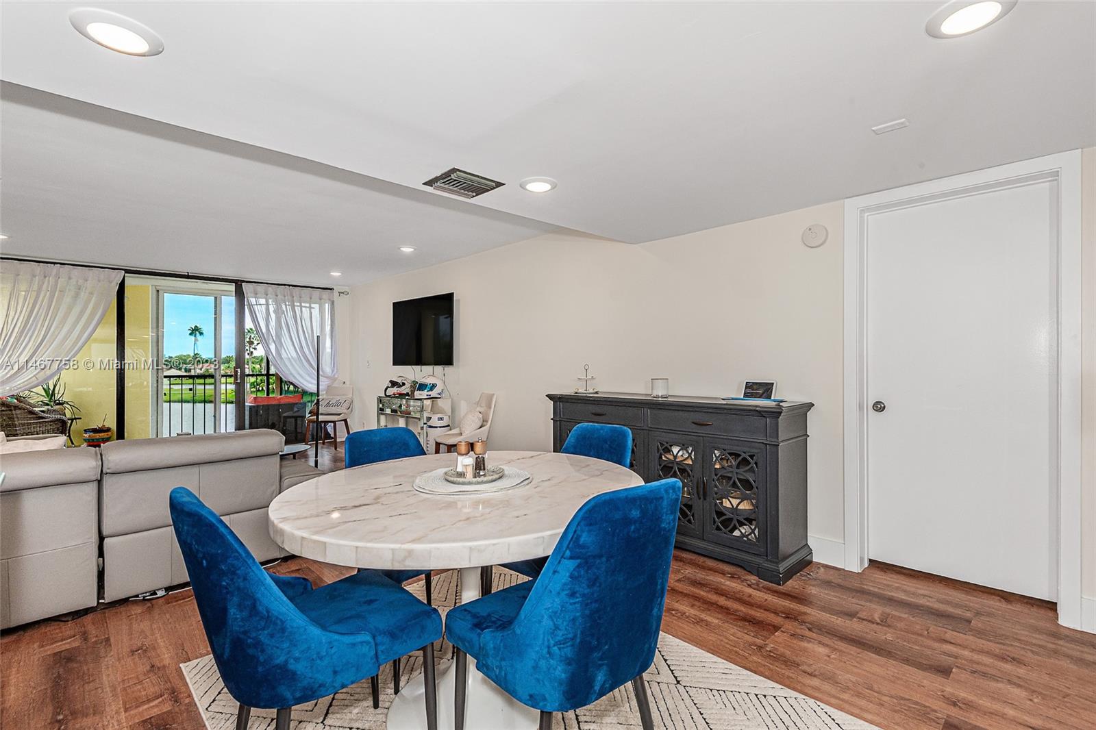 16401 Golf Club Road, Unit 311 Weston, FL 33326 - Photo 6 of 33 a view of a dining room with furniture window and wooden floor