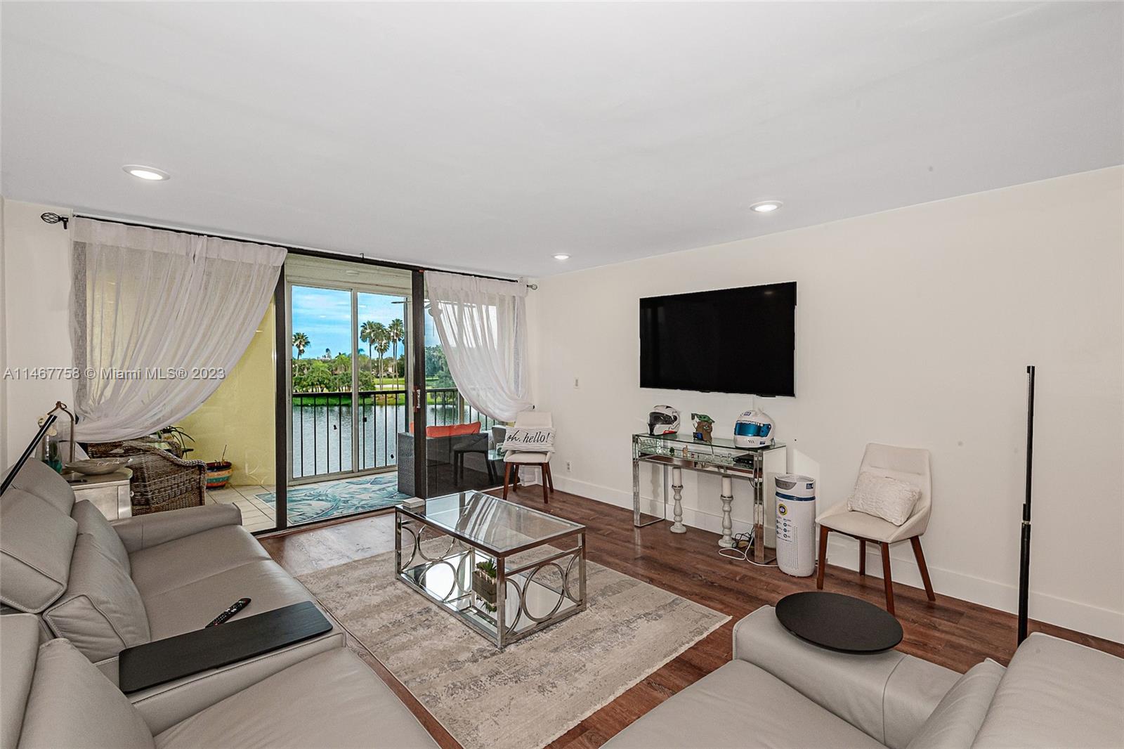 16401 Golf Club Road, Unit 311 Weston, FL 33326 - Photo 7 of 33 a living room with furniture and a flat screen tv