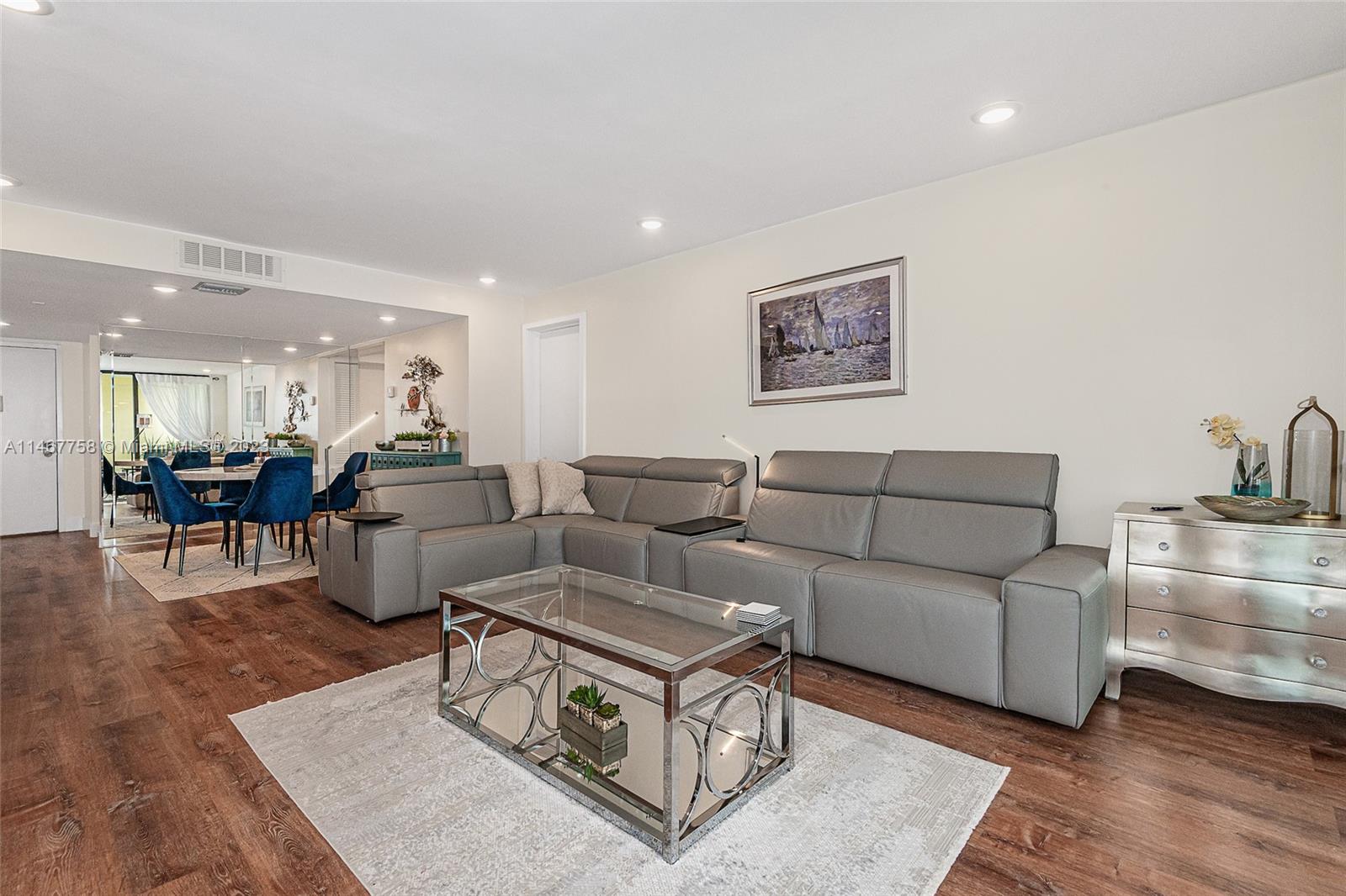 16401 Golf Club Road, Unit 311 Weston, FL 33326 - Photo 9 of 33 a living room with furniture wooden floor and a table