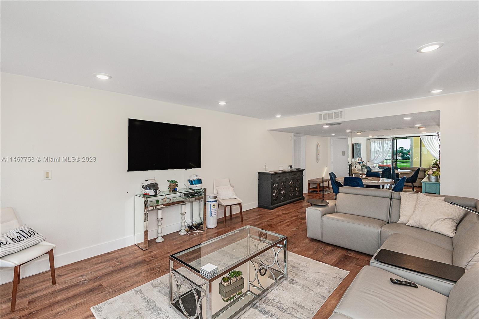 16401 Golf Club Road, Unit 311 Weston, FL 33326 - Photo 10 of 33 a living room with furniture and a flat screen tv