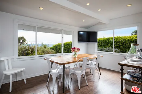 a view of a dining room with furniture window and wooden floor
