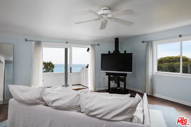 a living room with furniture tv and a window