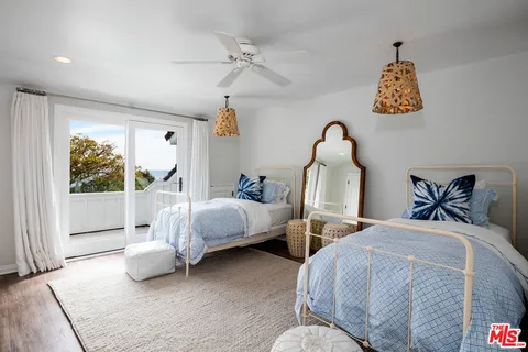 a bedroom with two beds and a window