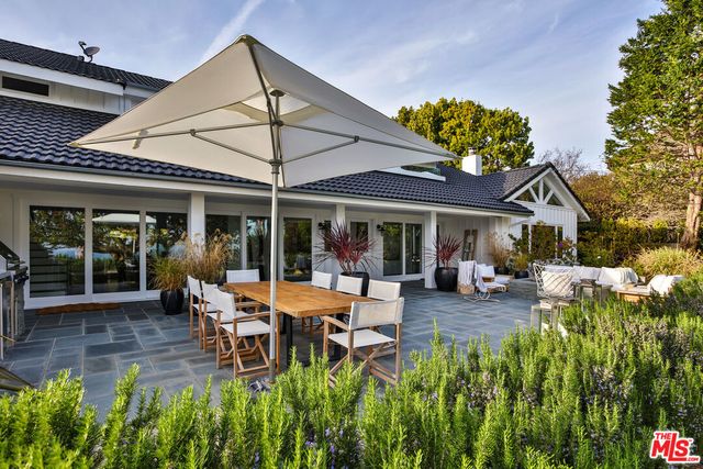 a view of a house with backyard porch and sitting area