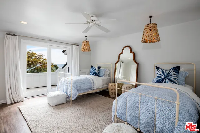 a bedroom with two beds and a window