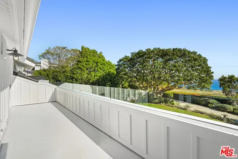 a view of a balcony with trees