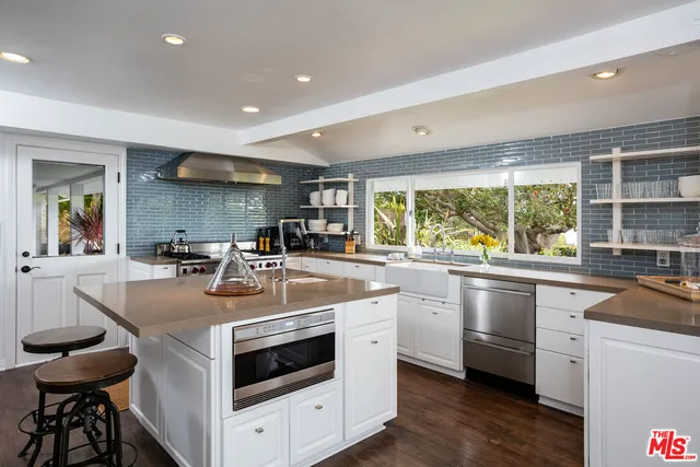 a kitchen with stainless steel appliances granite countertop a stove and a sink