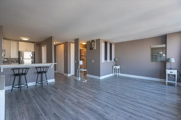 a view of kitchen with furniture and wooden floor