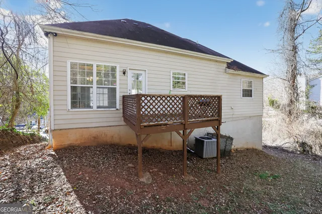 a view of a house with a yard and sitting area