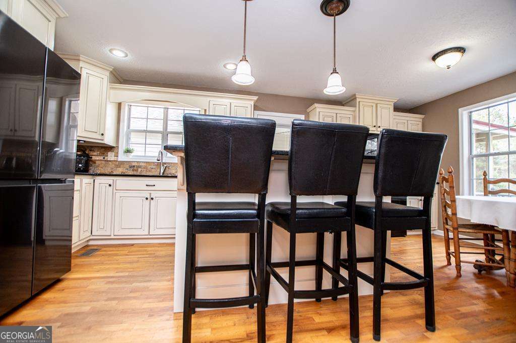 2 Pine Hill Drive Ranburne, AL 36273 - Photo 25 of 91 a kitchen with stainless steel appliances kitchen island granite countertop a refrigerator a stove a oven with white cabinets and wooden floor