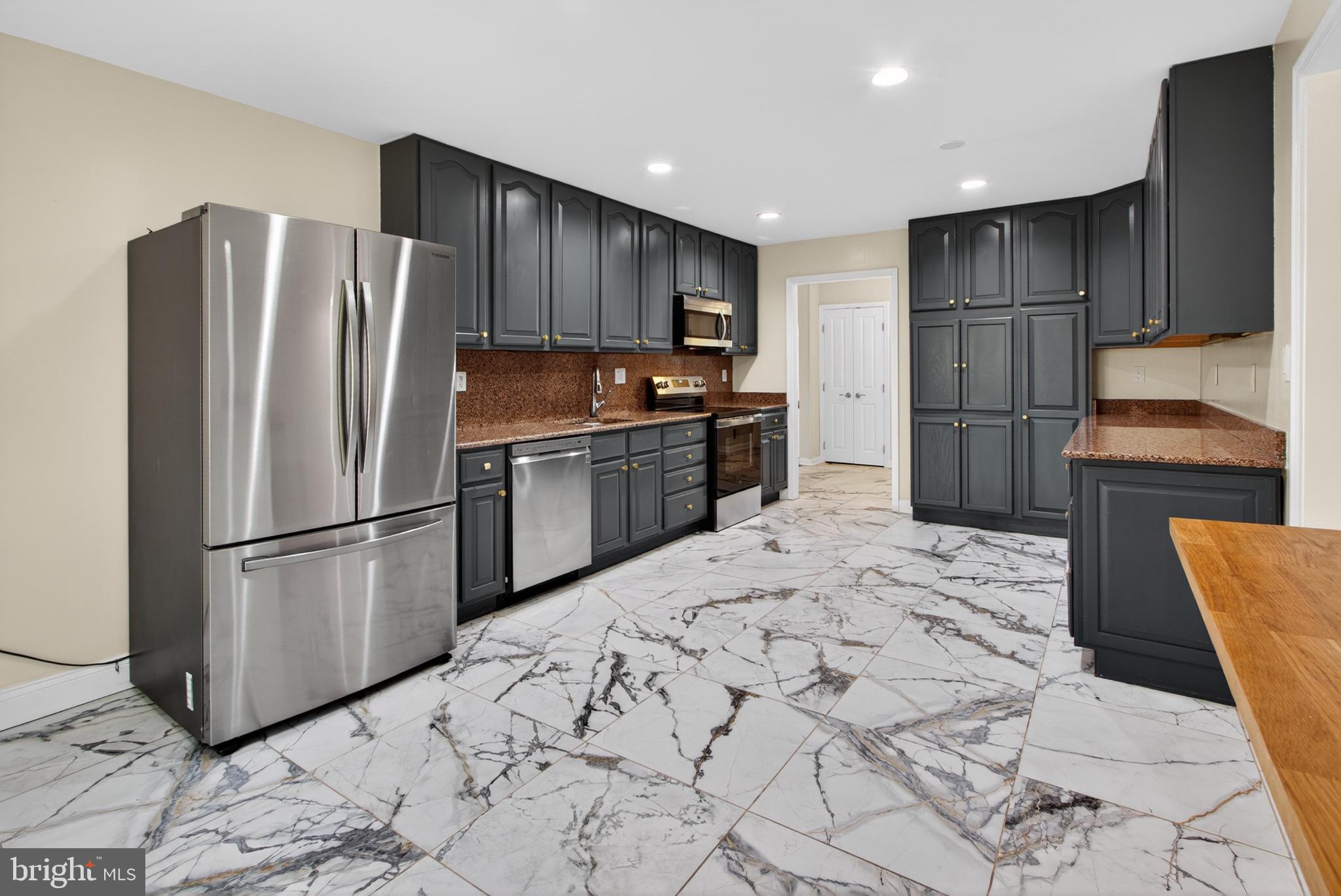 16 Redding Ridge Drive Gaithersburg, MD 20878 - Photo 13 of 53 Sleek kitchen with elegant marble floors.