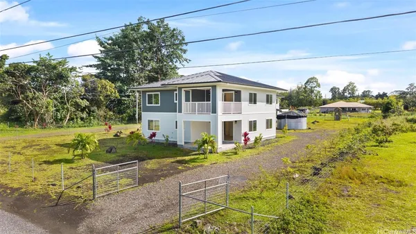 a front view of house with yard and trees