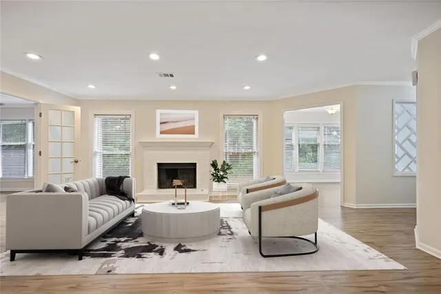 a living room with furniture a fireplace and a table