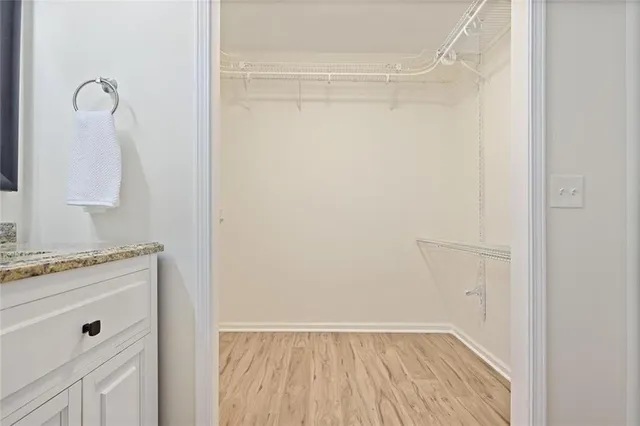 a view of walk in closet with empty racks