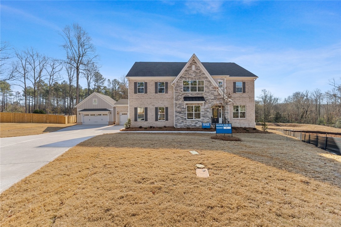 This newly constructed home features a charming blend of brick and stone.
