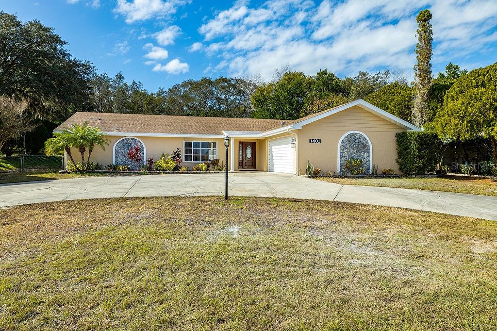 1401 Ivydale Road Spring Hill, FL 34606 - Photo 1 of 1 Huge circular driveway, Great Curb Appeal, The house has been freshly painted.