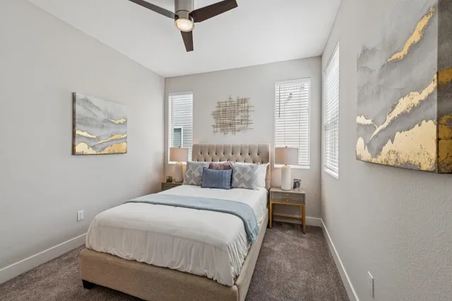 a bedroom with a bed and a painting on the wall