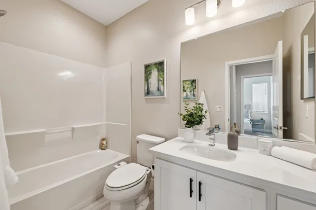 a bedroom with a bed and a painting on the wall