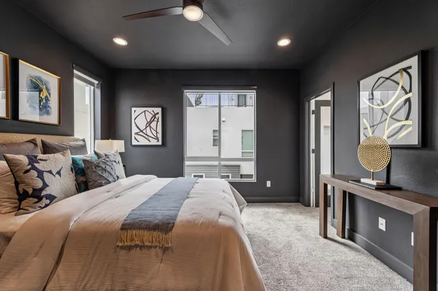 a spacious bedroom with a bed and a potted plant