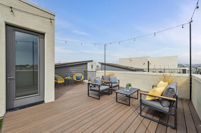 a backyard of a house with wooden floor and fence