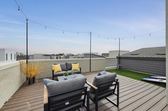 a view of a wooden chairs in a balcony