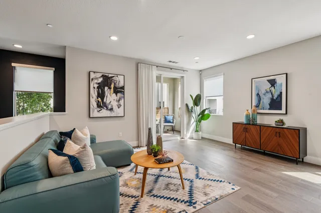 a living room with furniture and wooden floor
