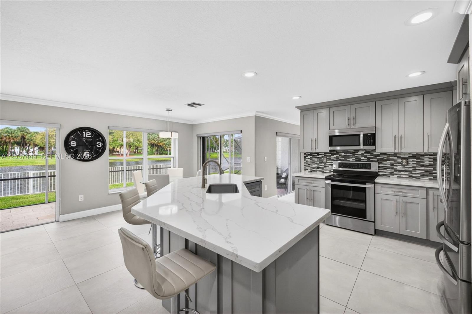 17488 Southwest 28th Court Miramar, FL 33029 - Photo 16 of 50 a kitchen with a stove a sink and a refrigerator