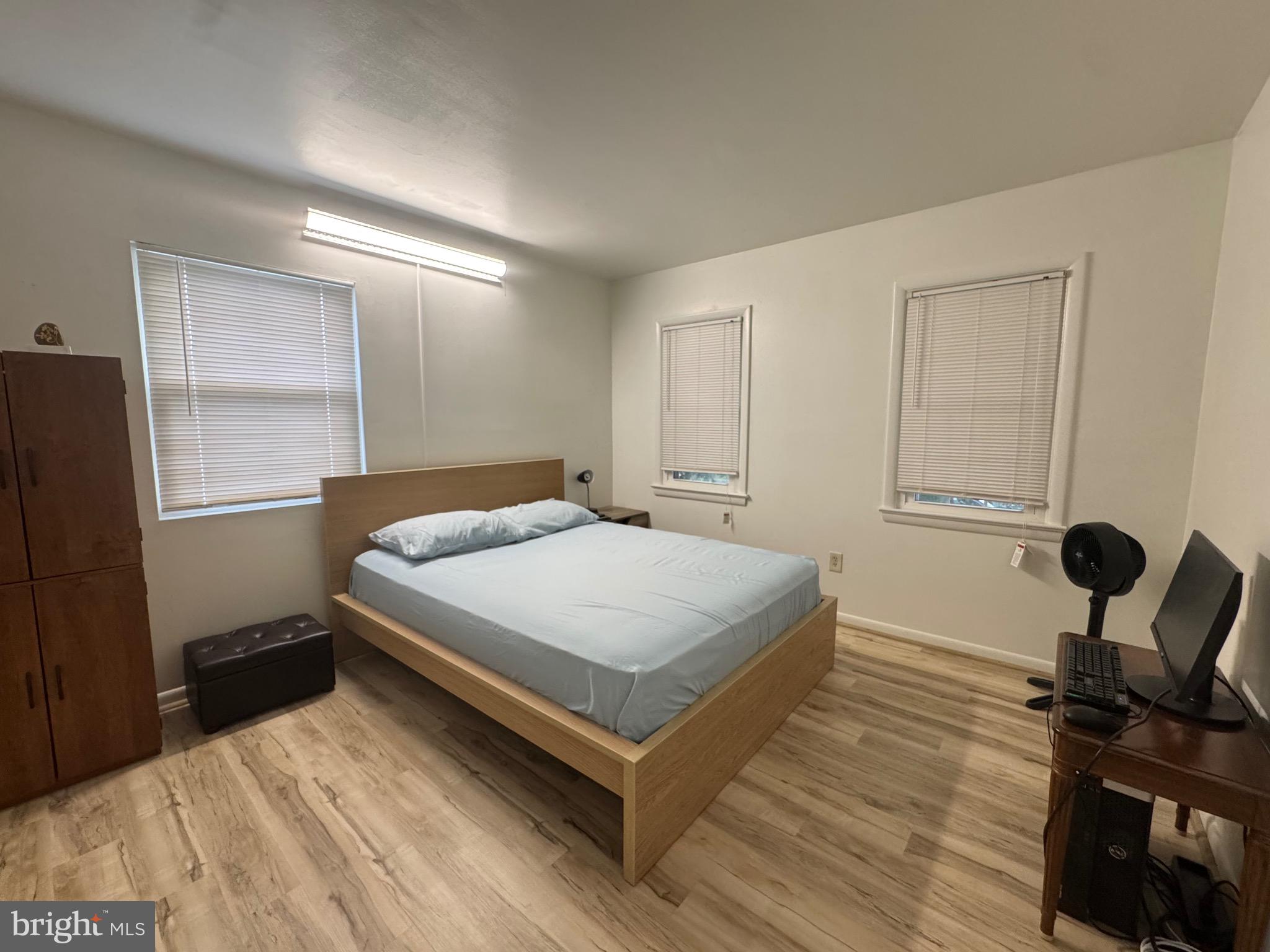 212 11th Street Laurel, MD 20707 - Photo 14 of 39 a bedroom with a bed and wooden floor