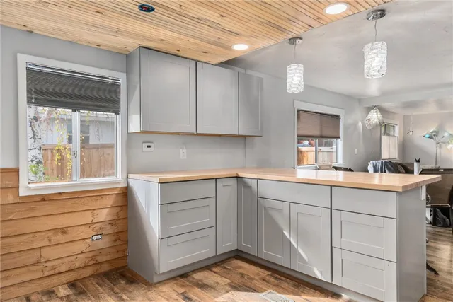 a kitchen with a sink cabinets and window