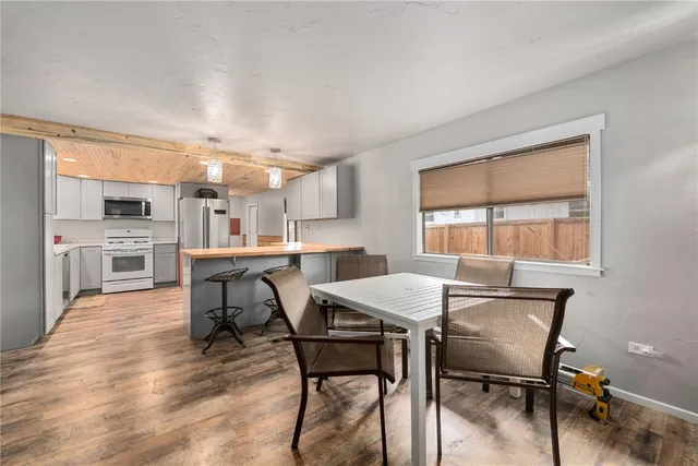 a dining room with furniture and wooden floor