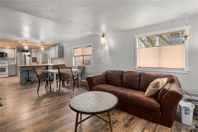 a living room with furniture a wooden floor and a window